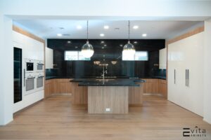 Modern Mocha-Toned Custom Kitchen With Black Marble Countertop